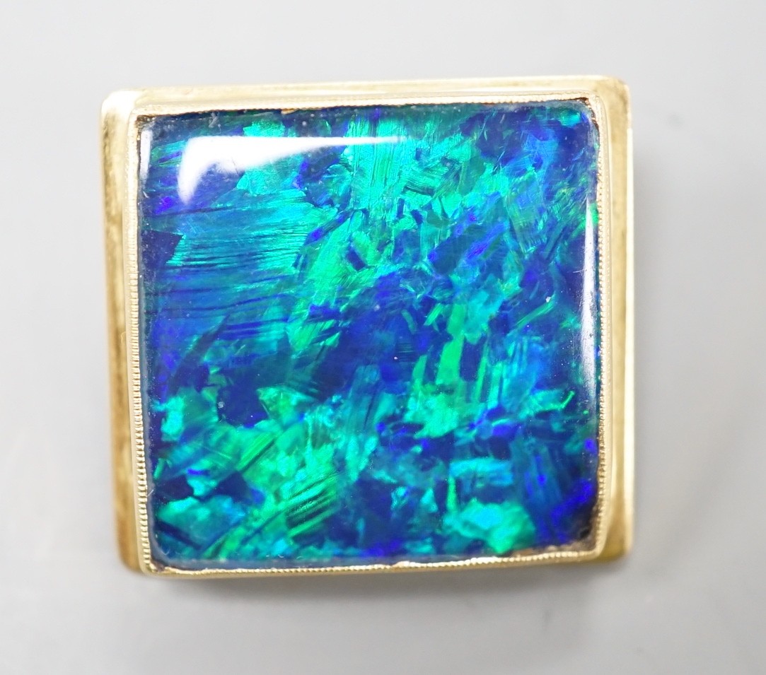 An 18ct mounted black opal doublet square cufflink, 23mm, gross weight 11.6 grams.